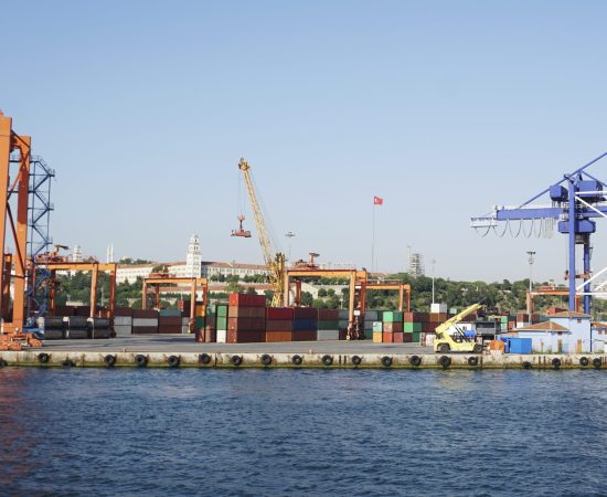 Crane lifting shipping containers at the seaport